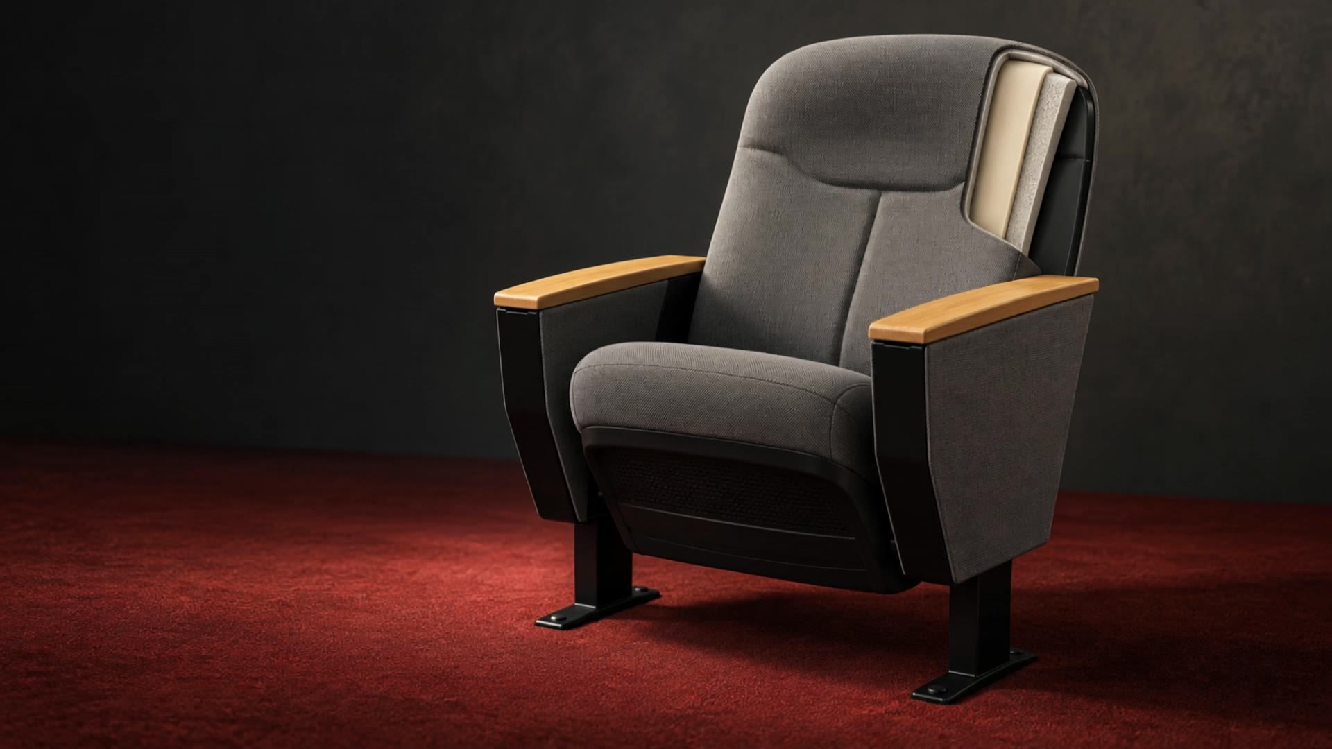Illustrative grey auditorium chair with visible cushioning layers against a burgundy floor